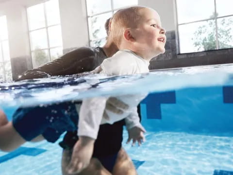 a boy holding a dolphin