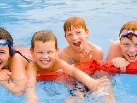 a group of children in a pool