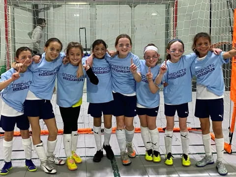 a group of girls in blue shirts