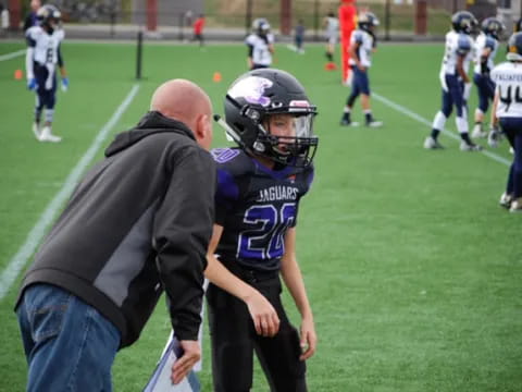 a football player talking to a coach