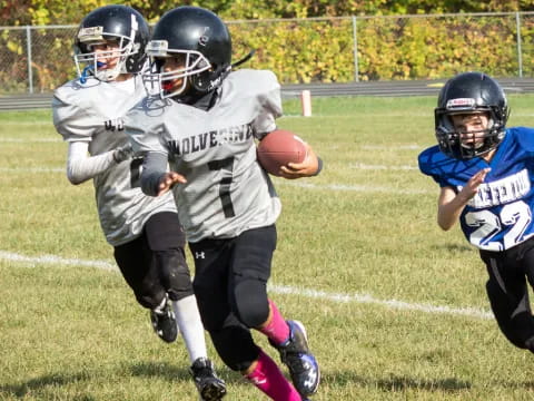 a group of kids playing football