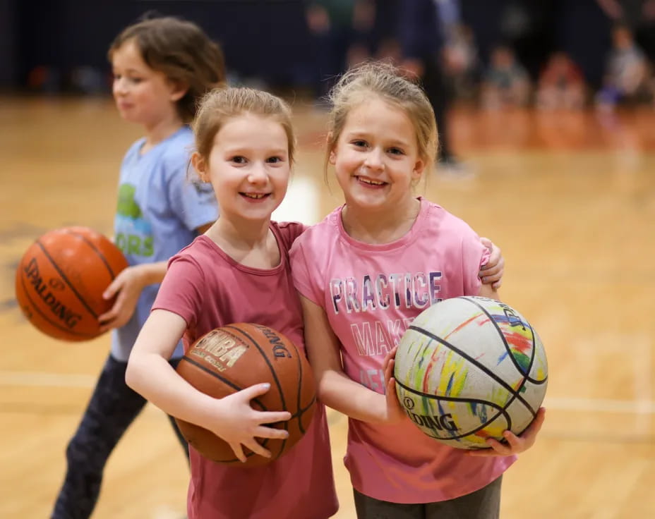 a group of girls holding basketballs