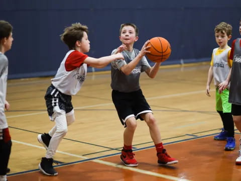 a group of kids playing basketball