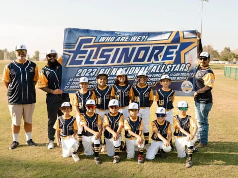 a group of people posing for a photo with a sign behind them