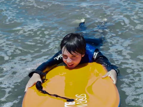 a boy in a life jacket in the water