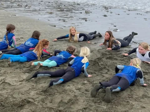 a group of people lying on the beach