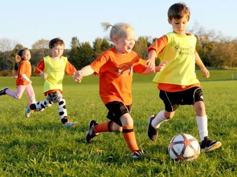 a group of kids playing football