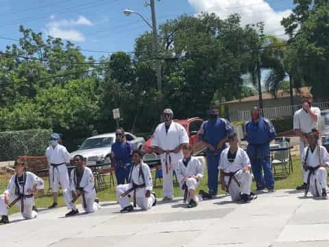 a group of people wearing white robes and holding swords