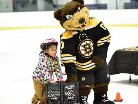 a child standing next to a mascot