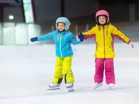 two children wearing ice skates