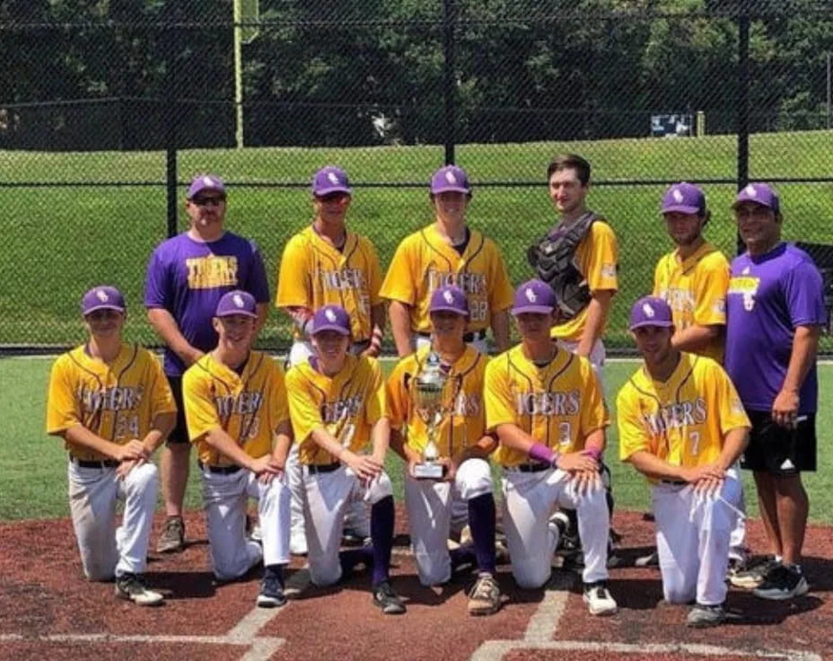 a group of baseball players pose for a photo