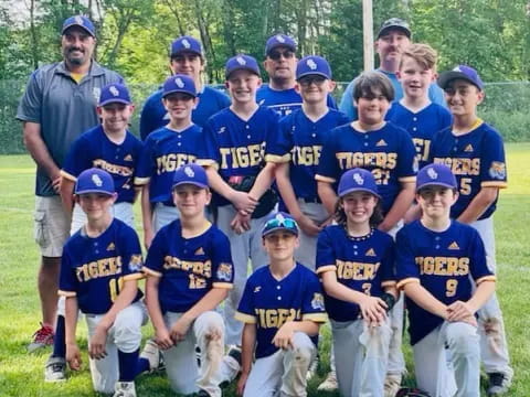 a group of kids in baseball uniforms