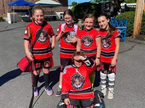 a group of kids wearing hockey uniforms