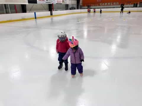 two children on an ice rink