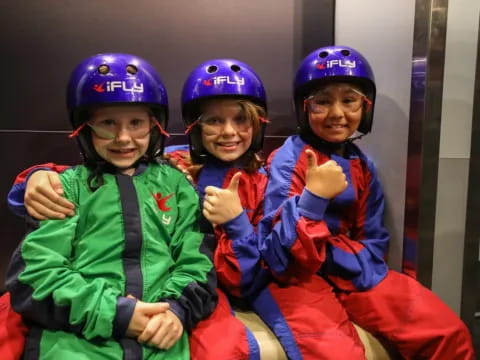 a group of kids wearing helmets and posing for a photo