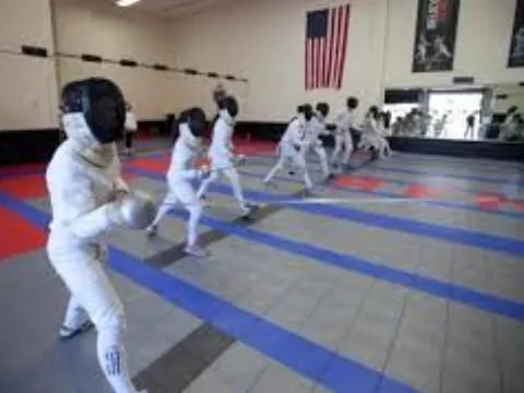 a group of people in white uniforms practicing martial arts