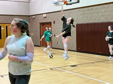 a group of people playing basketball
