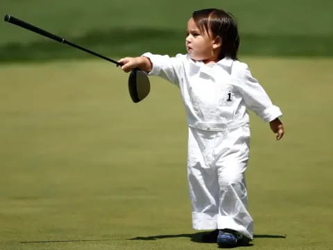 a young girl playing golf