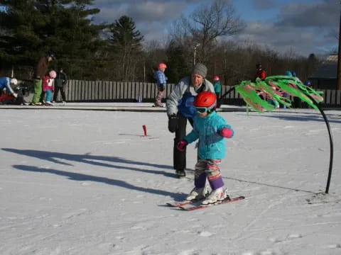 a person and a child on skis in the snow