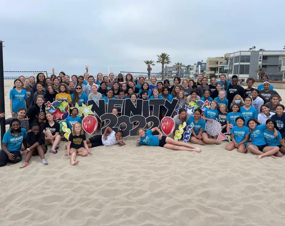 a group of people posing for a photo on a beach