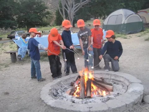 a group of people around a fire