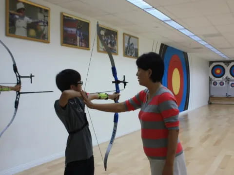 a couple of boys shooting bows