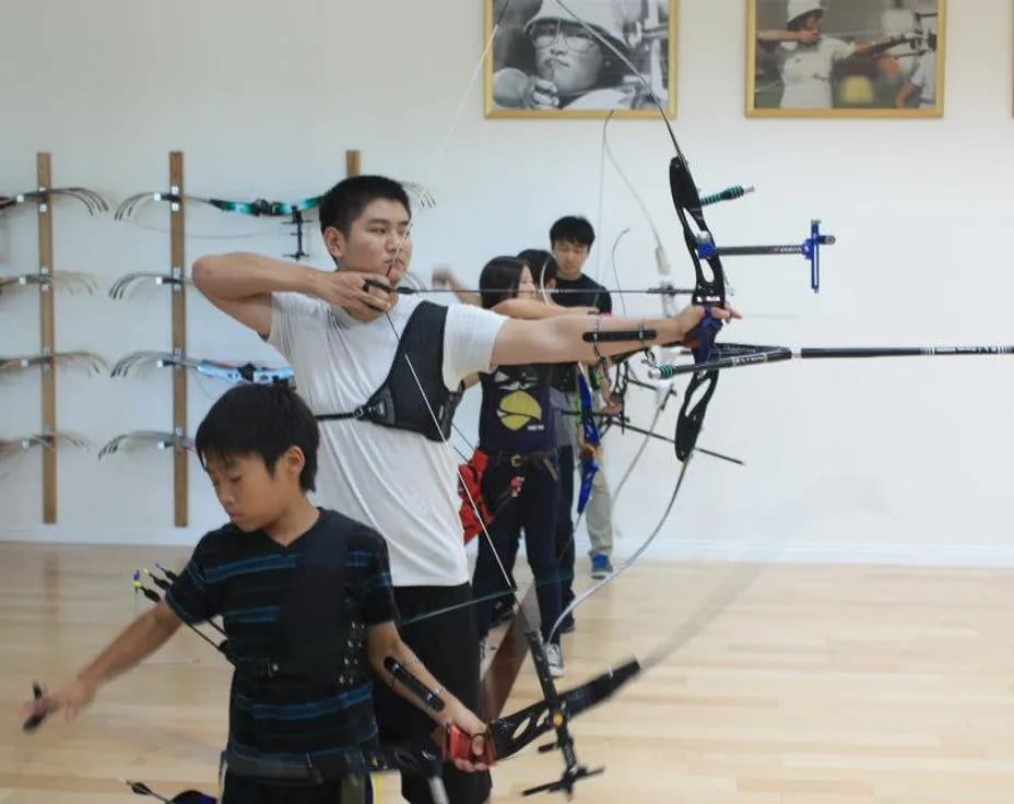 a group of people holding bows and arrows
