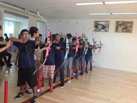 a group of people holding bows and arrows