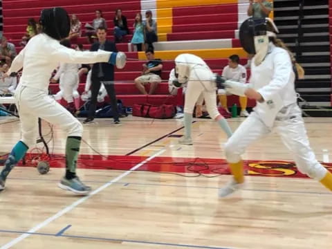 a group of people in white uniforms practicing martial arts