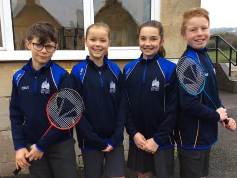 a group of boys holding tennis rackets