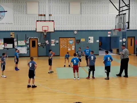 a group of people playing basketball