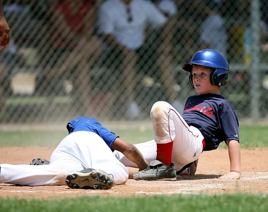 a baseball player sliding into home plate