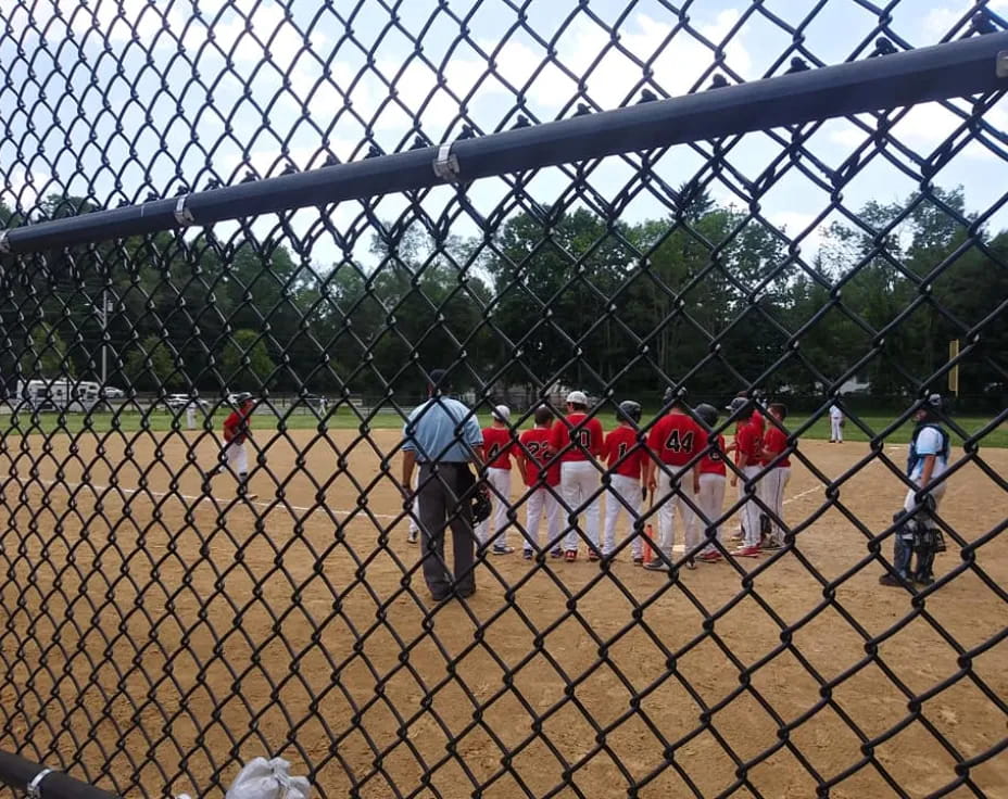 a group of people playing baseball