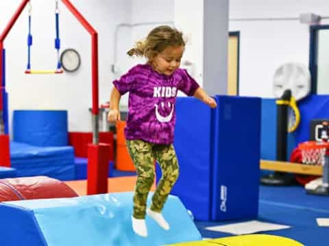 a girl jumping on a trampoline