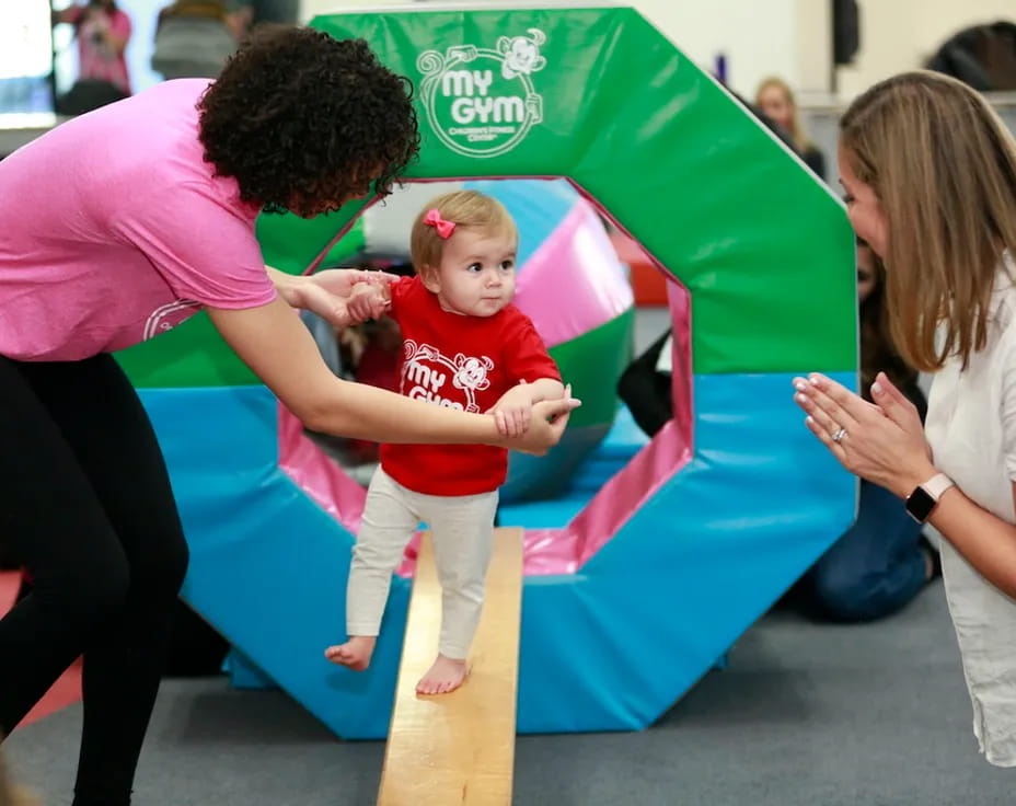 a woman and a child playing in a large ball