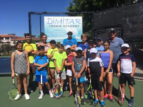 a group of people holding tennis rackets