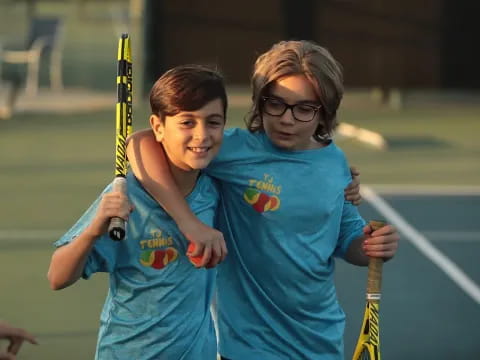 a couple of girls holding tennis rackets