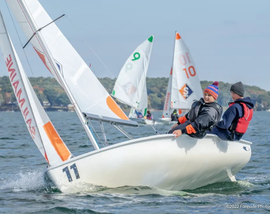 a group of people on a sailboat on the water