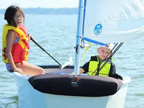 a man and a woman on a sailboat