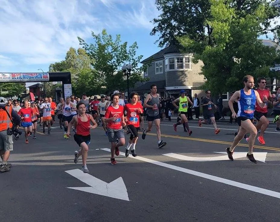 a group of people running on a street