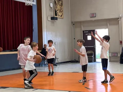 a group of kids playing basketball