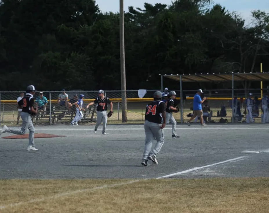 a group of people playing baseball