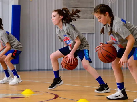 a group of girls playing basketball