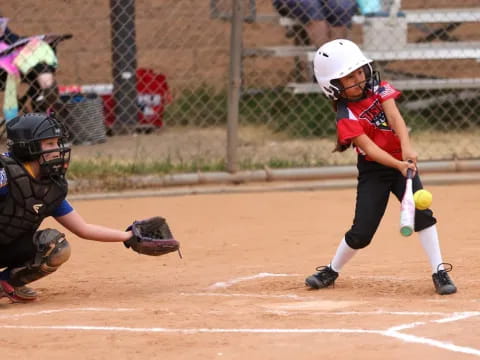 a girl swinging a baseball bat