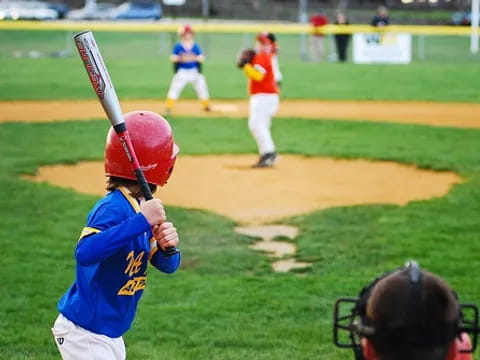 a kid holding a baseball bat