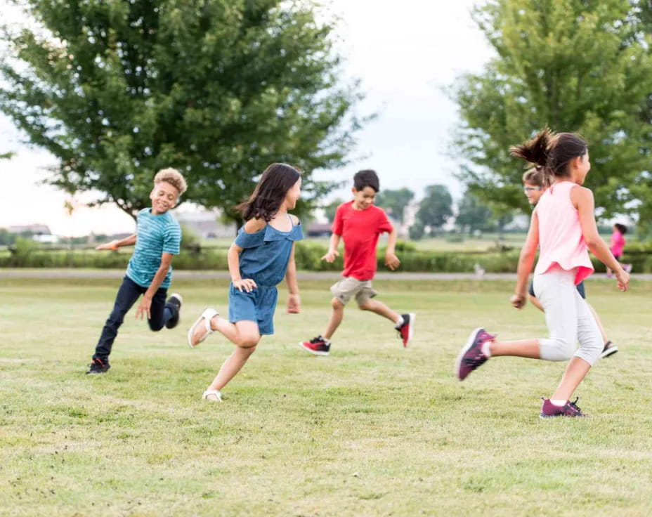 a group of children running on a field