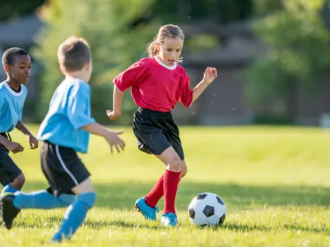 kids chasing a football ball