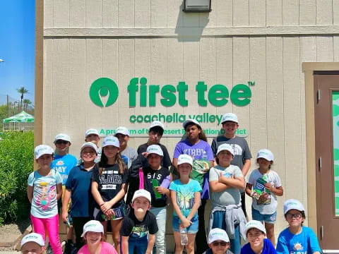 a group of people posing for a photo in front of a building