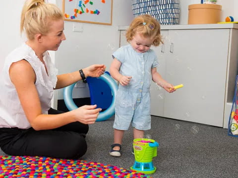 a person and a child playing with toys