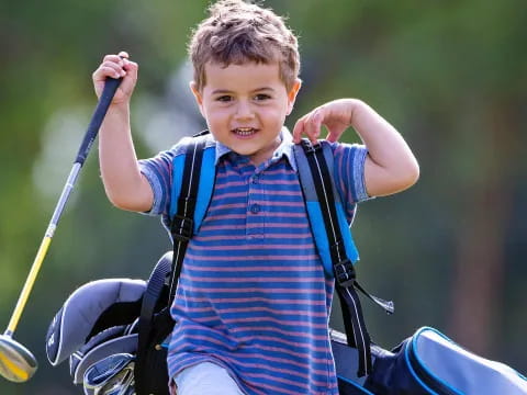a boy holding a golf club